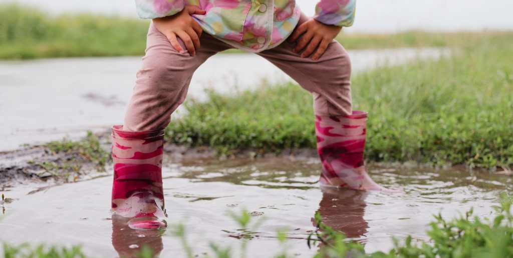 nursery child playing in a puddle in rugby